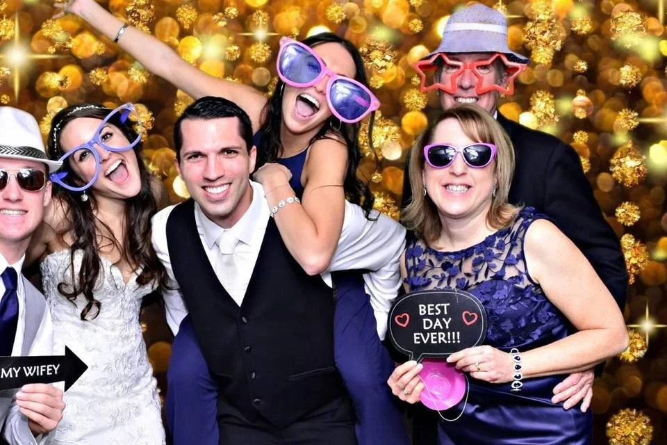 Couple laughing in Rumba Houston Photo Booth with fun props